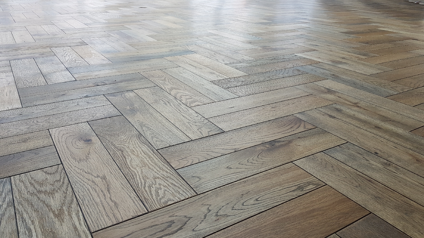 Oak herringbone flooring seen at a low angle