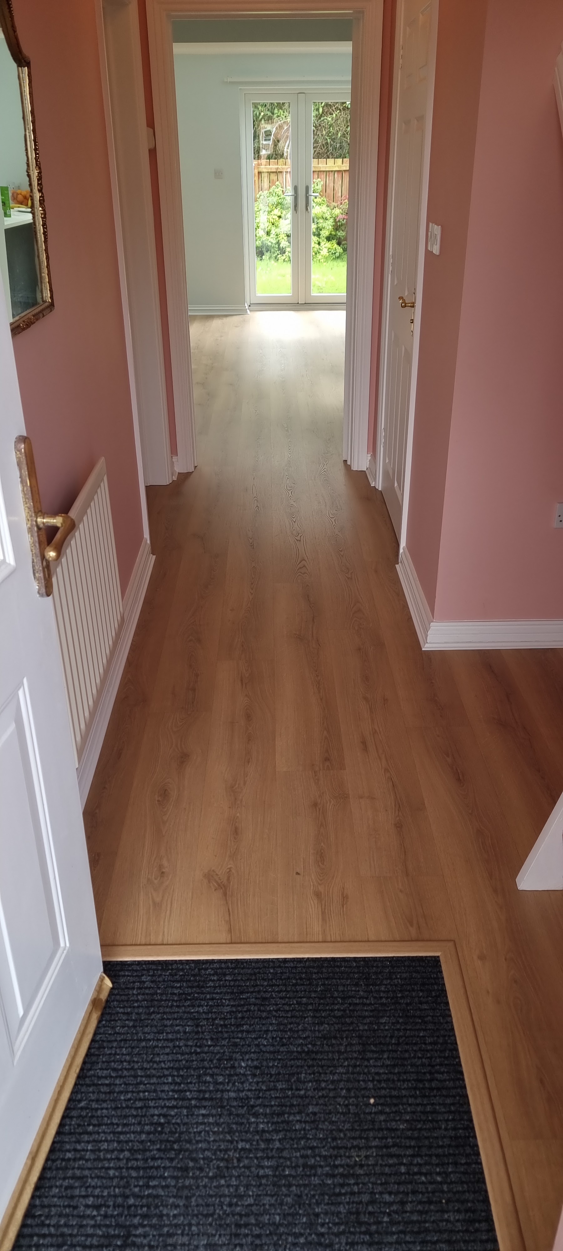 A hallway with a new wood-effect floor