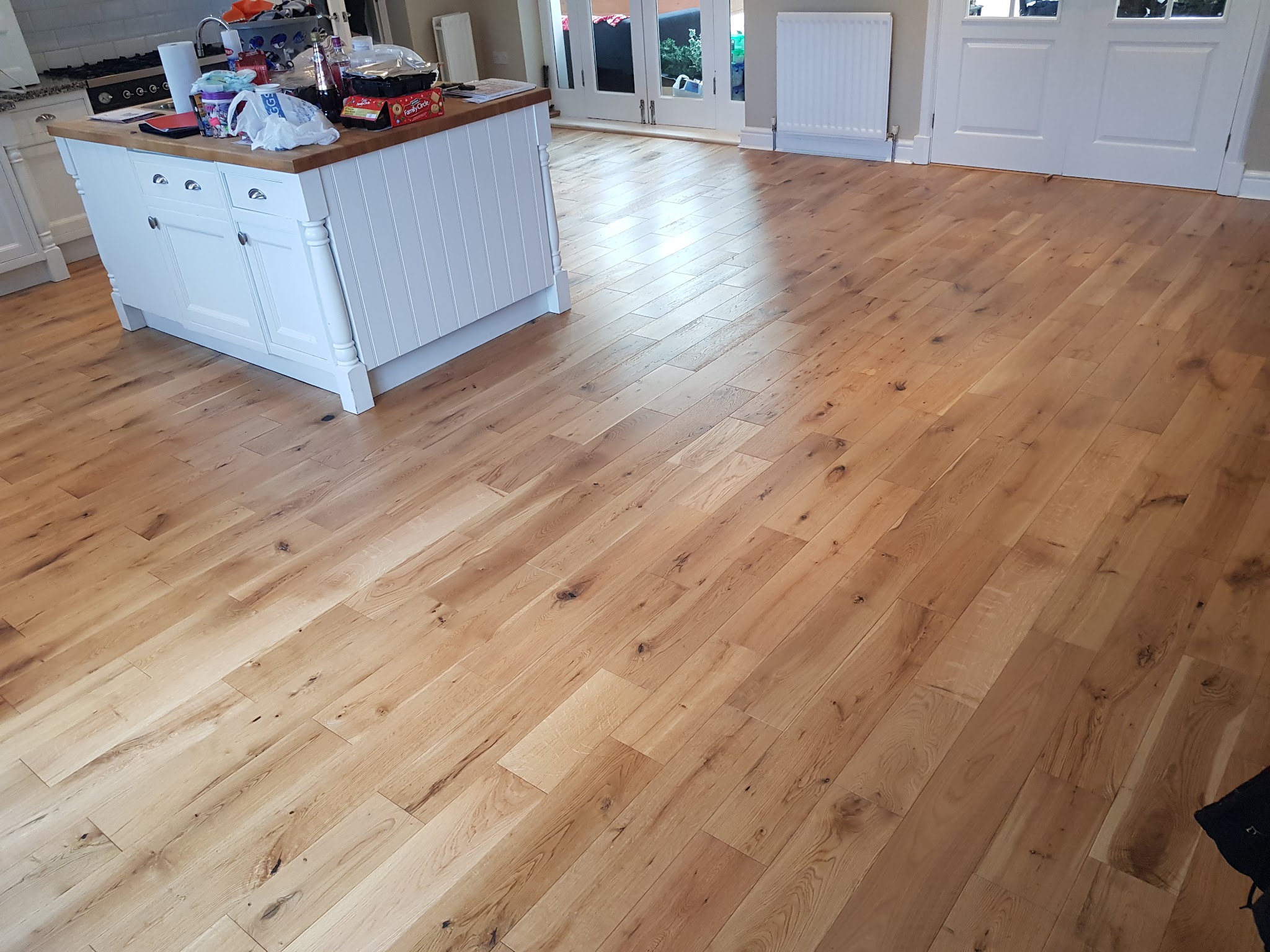 An oak floor running through an open kitchen