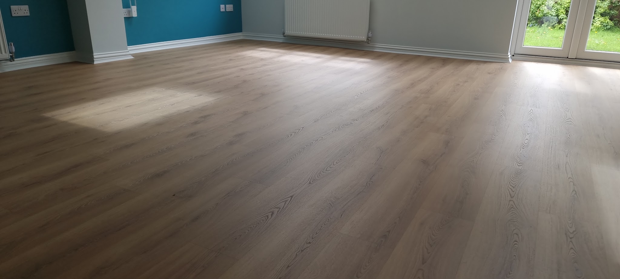A grey wood-effect floor in an open room